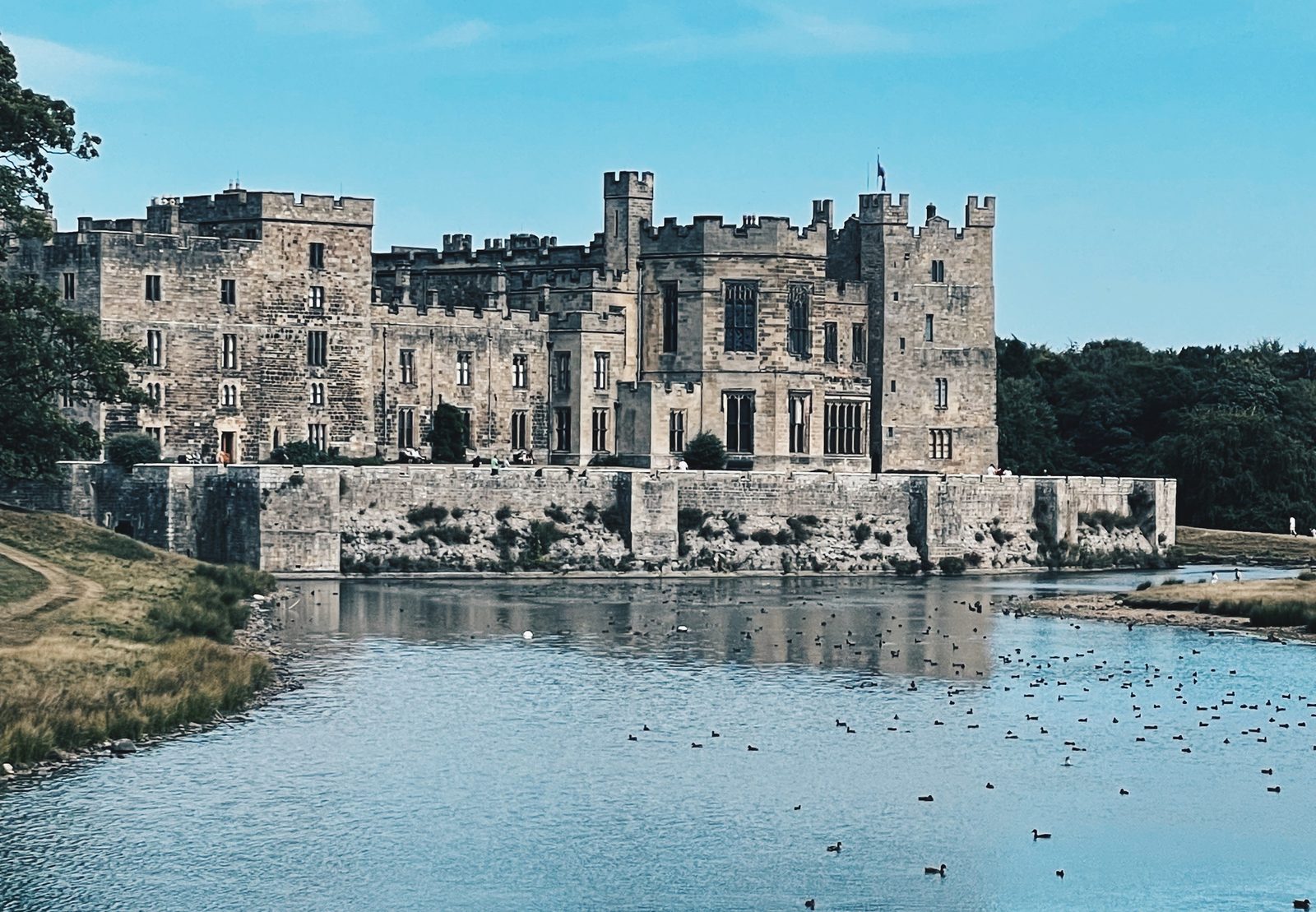Raby Castle reflected in its lake